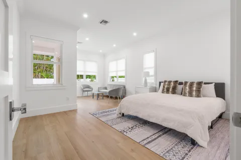 a bedroom with a bed a table and chair