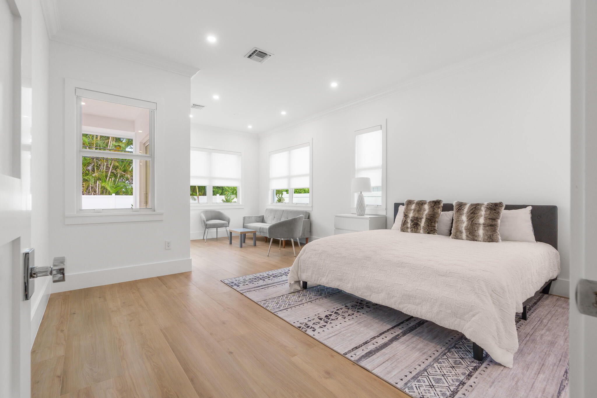 803 Sunset Road Boynton Beach, FL 33435 - Photo 22 of 57 a spacious bedroom with a large bed and a table