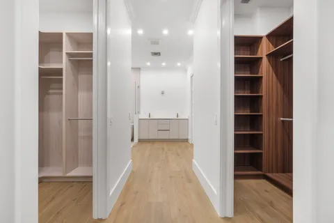 a view of walk in closet with empty racks