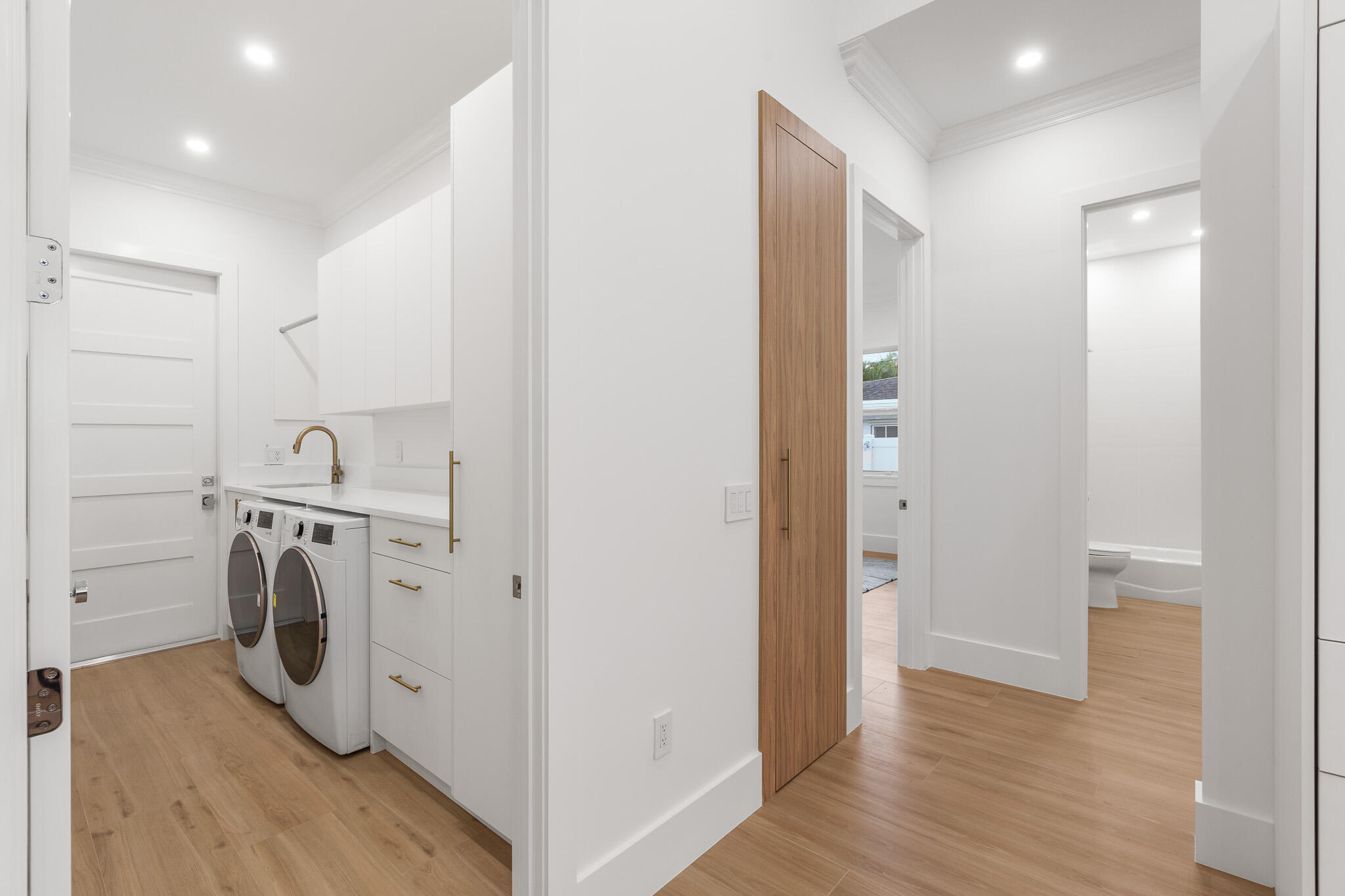 803 Sunset Road Boynton Beach, FL 33435 - Photo 40 of 57 a view of a storage & utility room with wooden floor