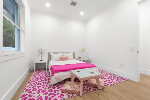 a bed sitting in a bedroom next to a window