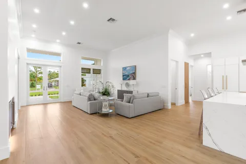 a living room with fireplace furniture and a wooden floor
