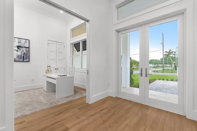 a view of a kitchen with a sink and dishwasher with wooden floor