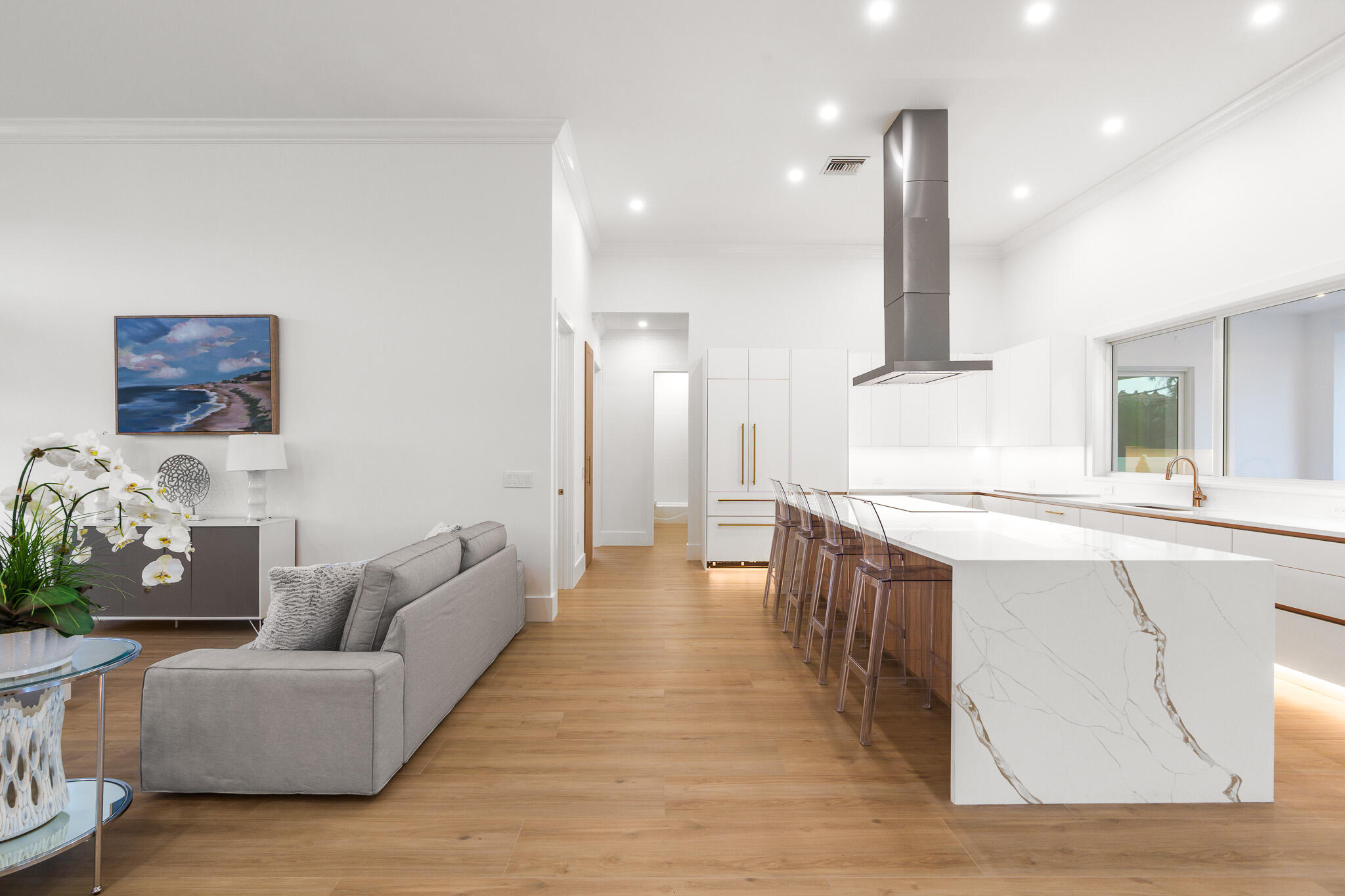 803 Sunset Road Boynton Beach, FL 33435 - Photo 8 of 57 a large living room with stainless steel appliances kitchen island granite countertop furniture and a wooden floor