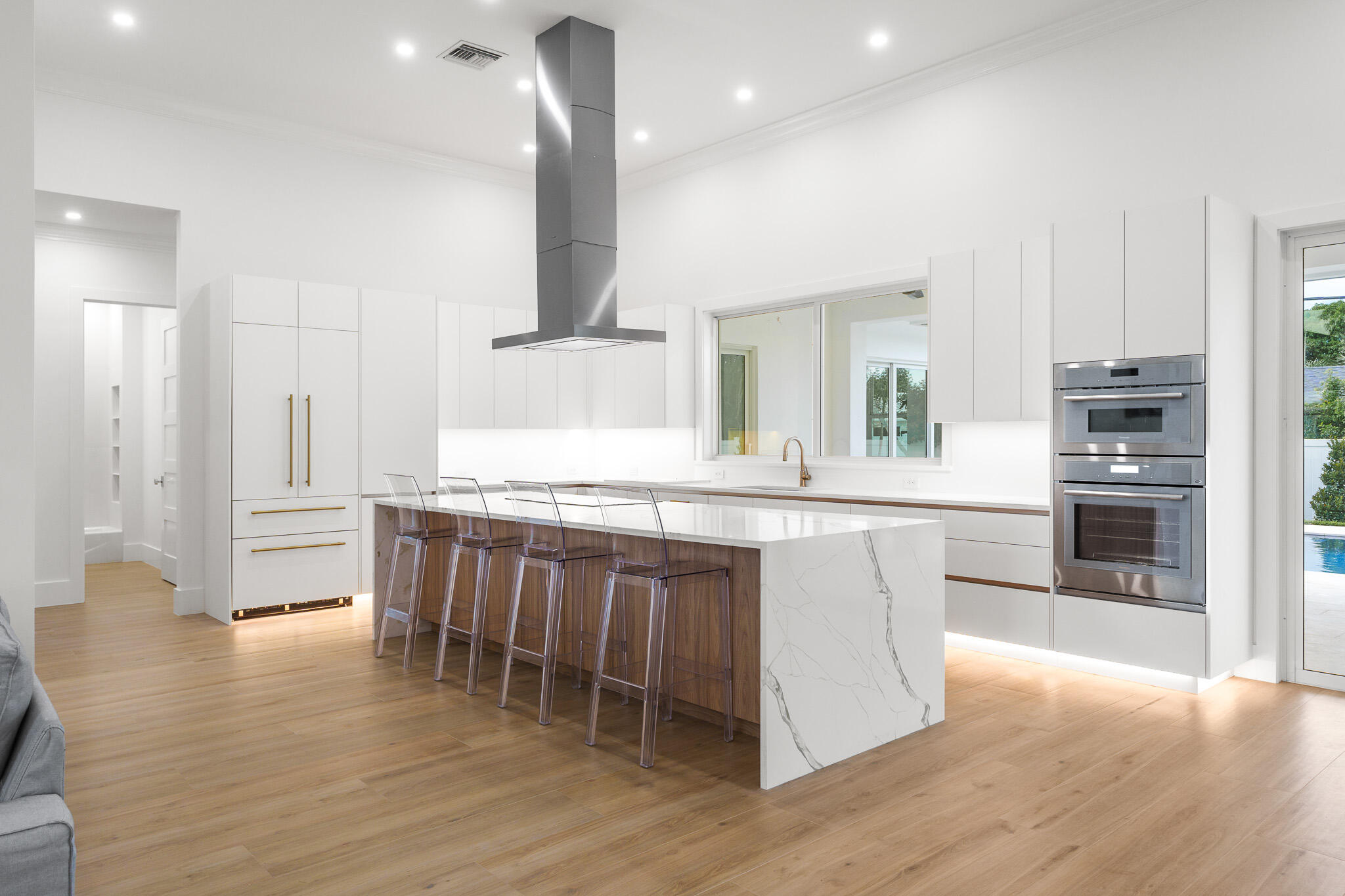 803 Sunset Road Boynton Beach, FL 33435 - Photo 9 of 57 a large kitchen with kitchen island a large counter top space a sink stainless steel appliances and cabinets