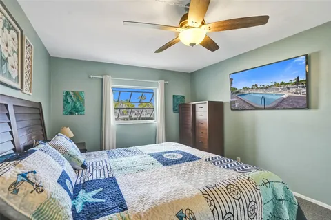 a bedroom with a bed and a painting on the wall