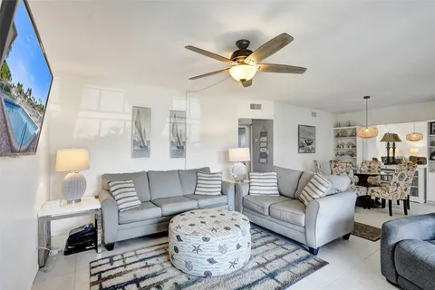 a living room with furniture a rug and a chandelier