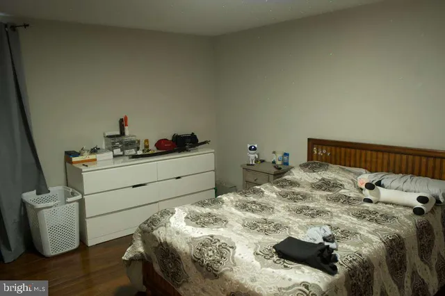 a bedroom with a bed a mirror and desk