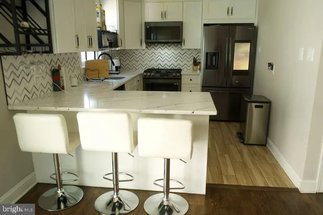 a kitchen with sink refrigerator and microwave