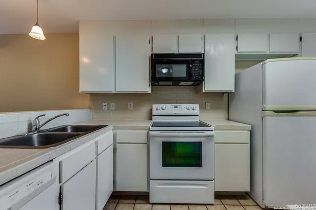 a kitchen with a sink and a stove top oven
