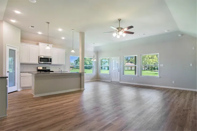 a view of kitchen with refrigerator and window