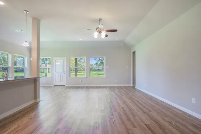 wooden floor in an empty room with a window