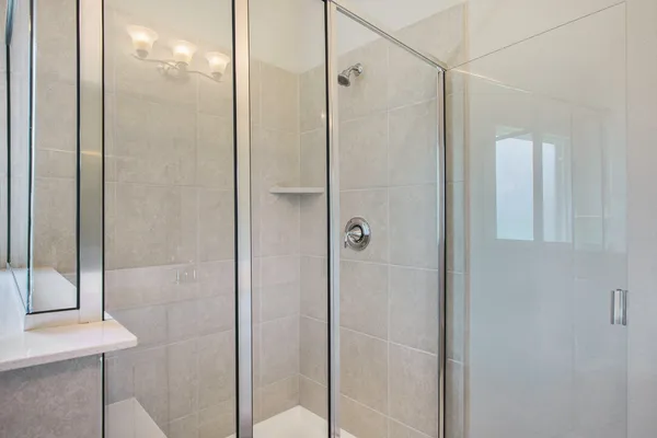 a bathroom with a glass shower door