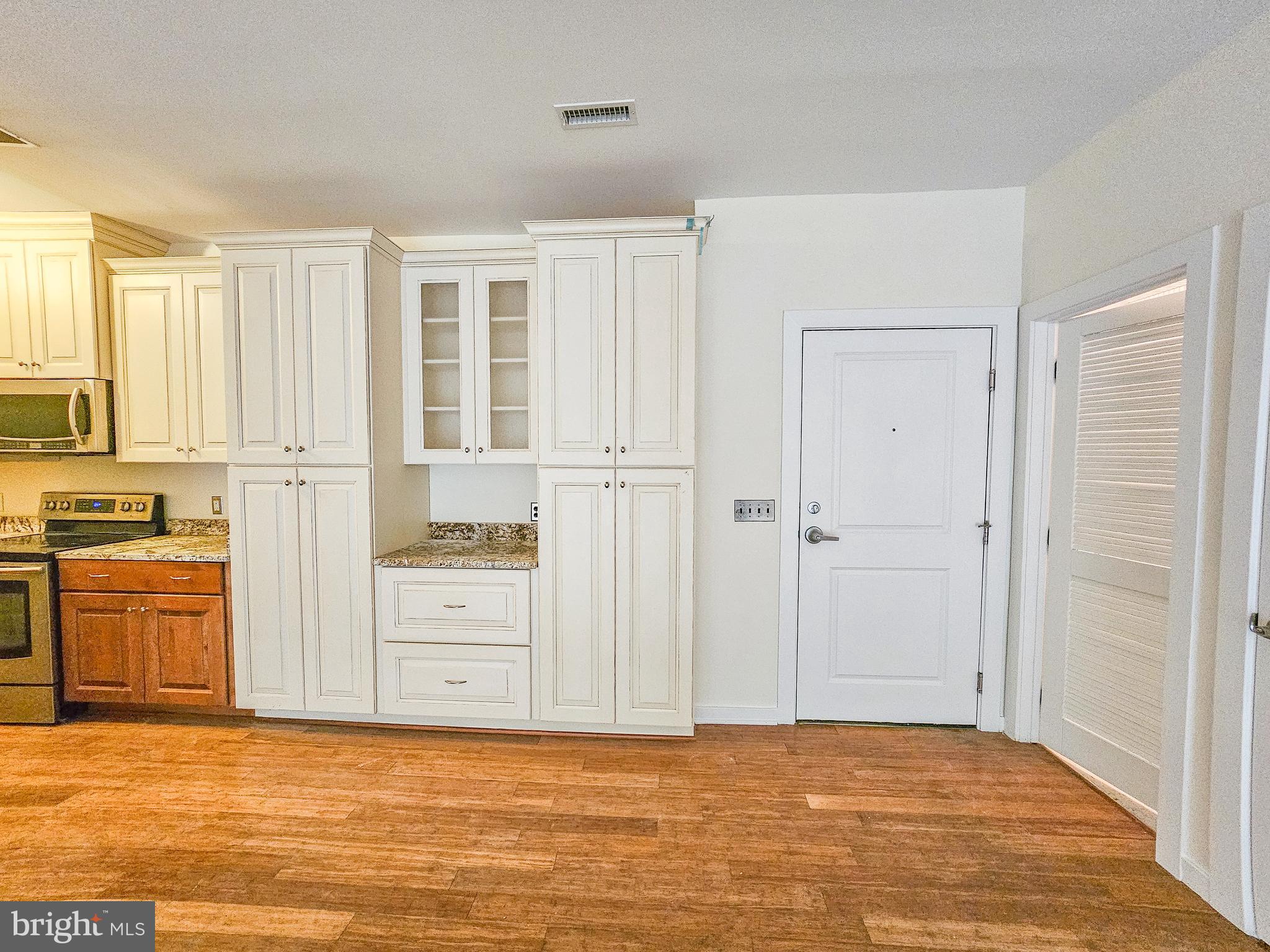 2007 Clipper Park Road, Unit 117 Baltimore, MD 21211 - Photo 3 of 30 a view of a kitchen with wooden floor and a sink