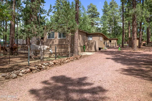 a wooden house with trees in the background