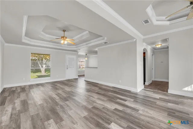 wooden floor in an empty room with a window