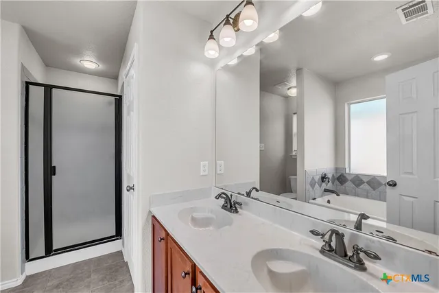 a bathroom with a sink double vanity and a mirror