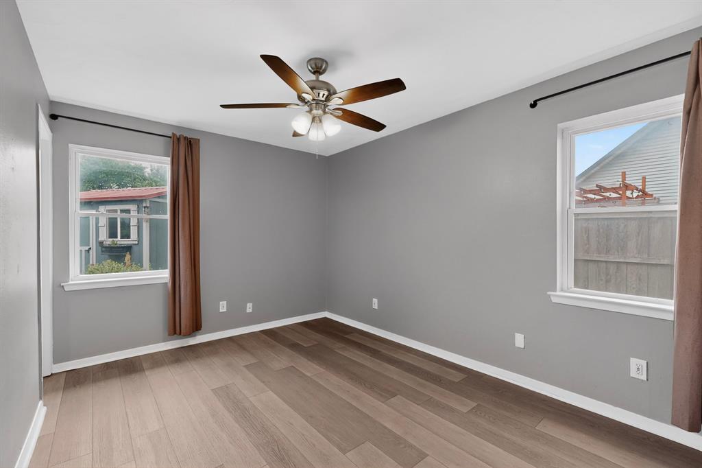 2309 Fyke Road Carrollton, TX 75006 - Photo 18 of 40 Room featuring contemporary gray wall paint, wood-finish flooring, and white trim
