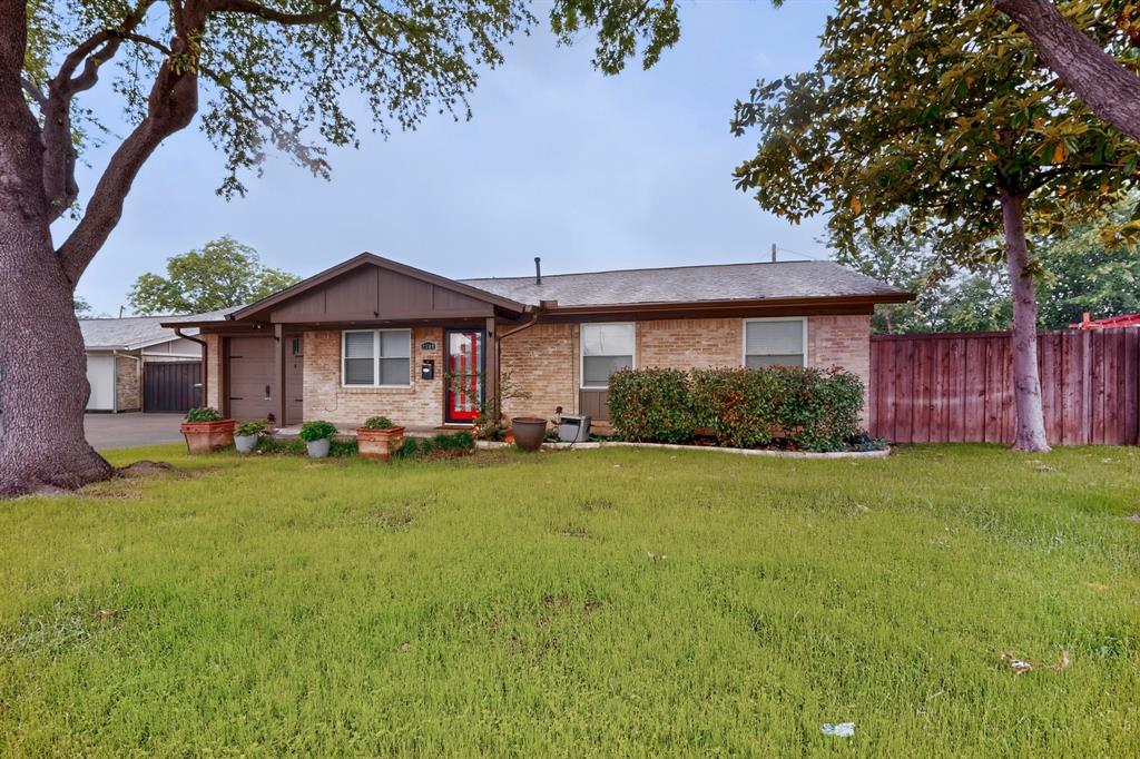 2309 Fyke Road Carrollton, TX 75006 - Photo 2 of 40 Brick facade residence featuring a recessed entry, attached garage, and a gabled porch roof