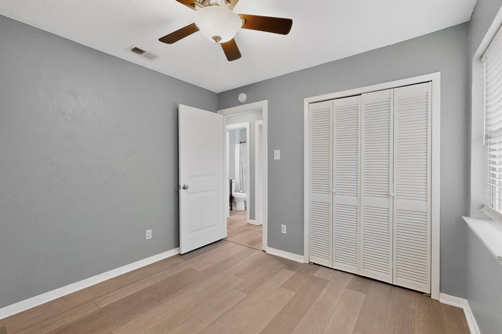 2309 Fyke Road Carrollton, TX 75006 - Photo 25 of 40 Room featuring wood-finish flooring, a ceiling fan with integrated lighting, and light gray walls