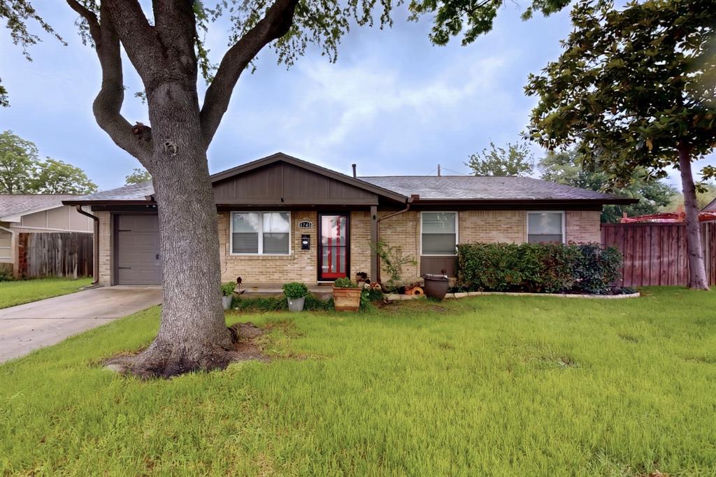 2309 Fyke Road Carrollton, TX 75006 - Photo 3 of 40 Brick exterior featuring a gabled roofline and attached garage