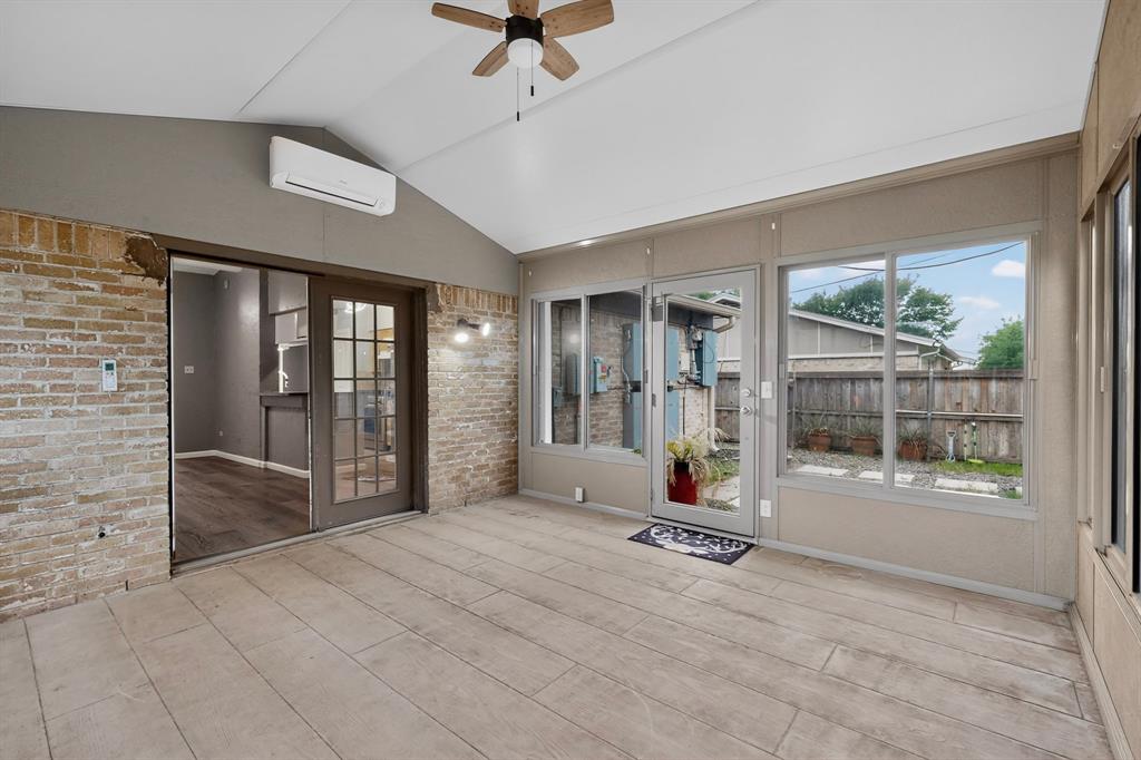 2309 Fyke Road Carrollton, TX 75006 - Photo 34 of 40 Enclosed patio featuring wood-finish flooring, a vaulted ceiling with a ceiling fan, and exposed brick walls