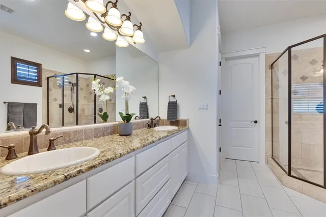 a spacious bathroom with a granite countertop tub sink and mirror