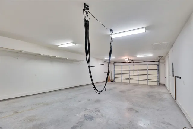 a picture of a room with a white wall and a white refrigerator