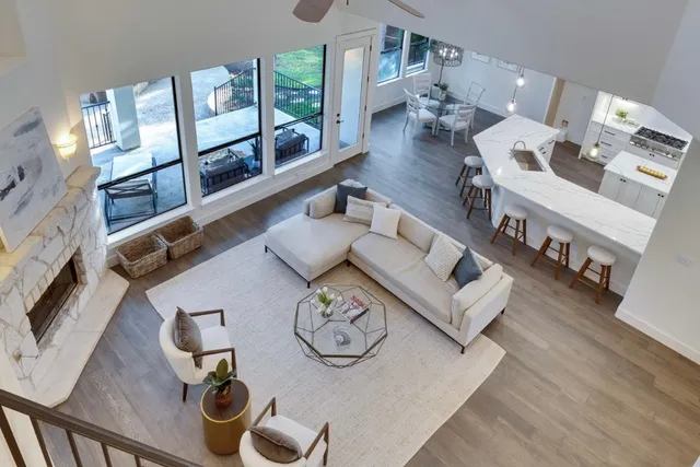 a large kitchen with kitchen island a large window in it