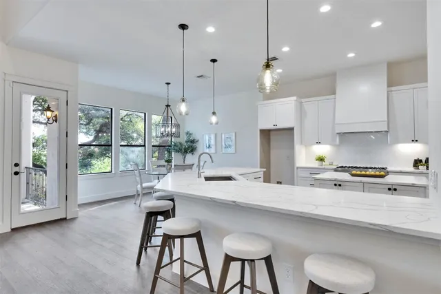a dining room with furniture a chandelier and wooden floor