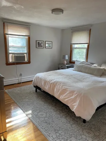 a bedroom with a bed and dresser