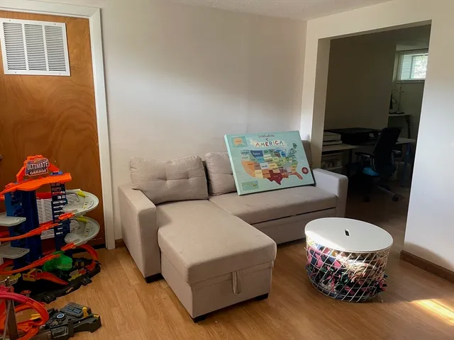 a living room with furniture and a rug