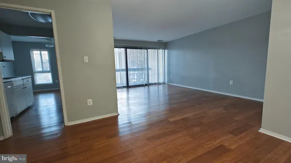 a view of a kitchen with wooden floor and a sink