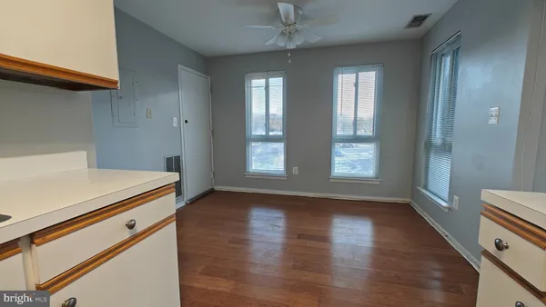 a kitchen with a stove white cabinets and a refrigerator