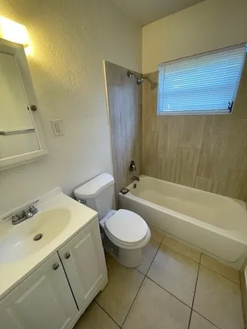 a bathroom with a sink a toilet and bathtub