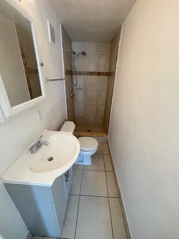 a bathroom with a sink mirror and toilet