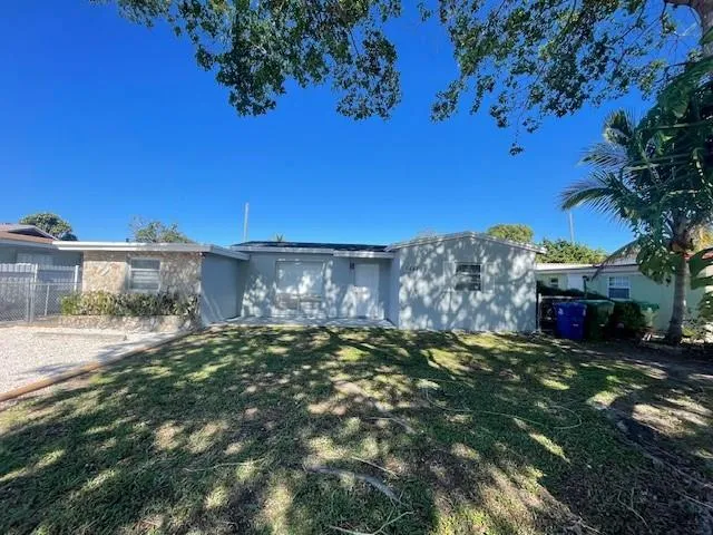 a view of a yard with plants and a building
