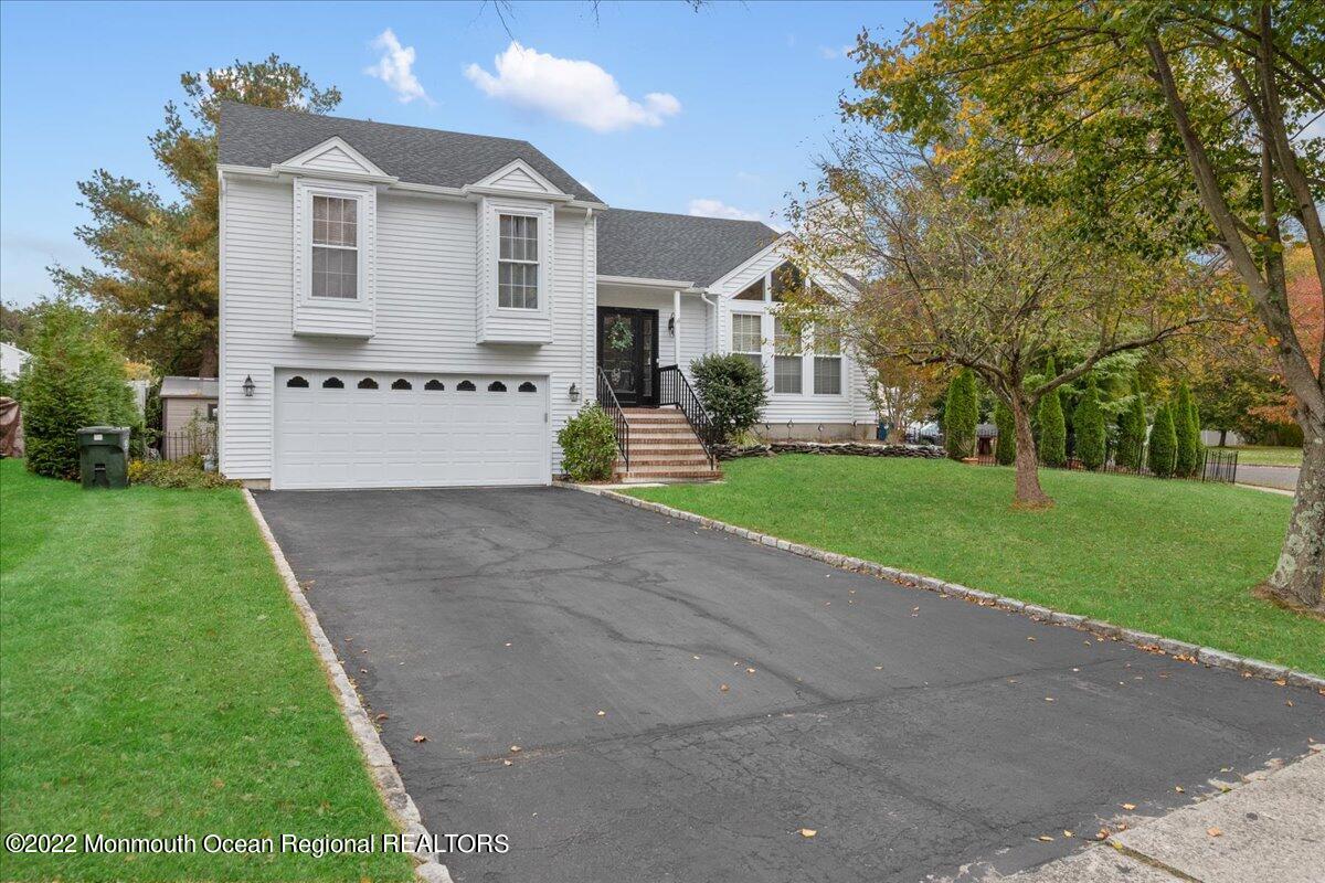 a front view of a house with a yard and garage