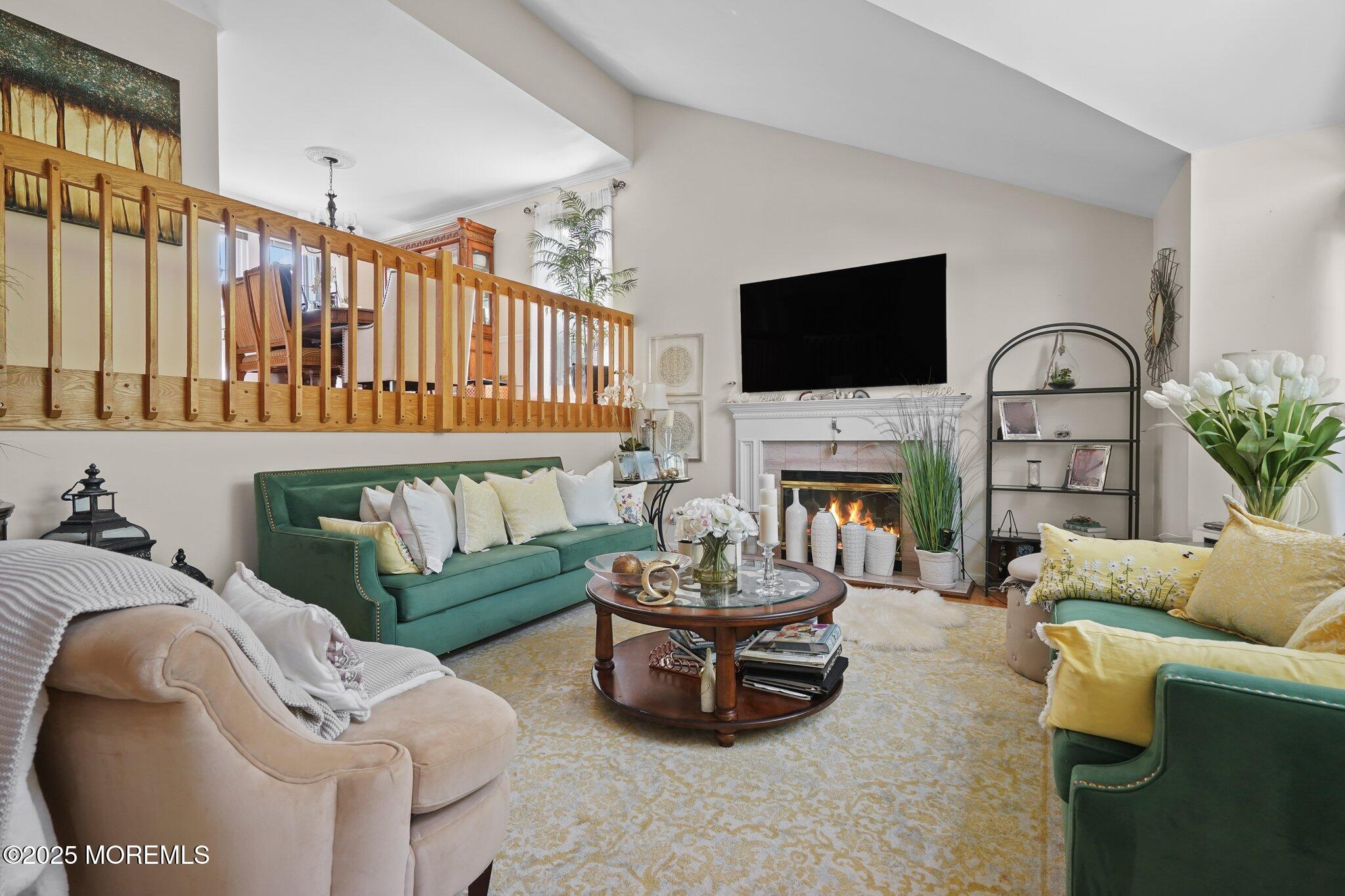 38 Sweet Gum Road Howell, NJ 07731 - Photo 19 of 23 a living room with furniture a fireplace and a flat screen tv