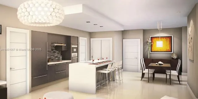 a room with a table chairs and a kitchen