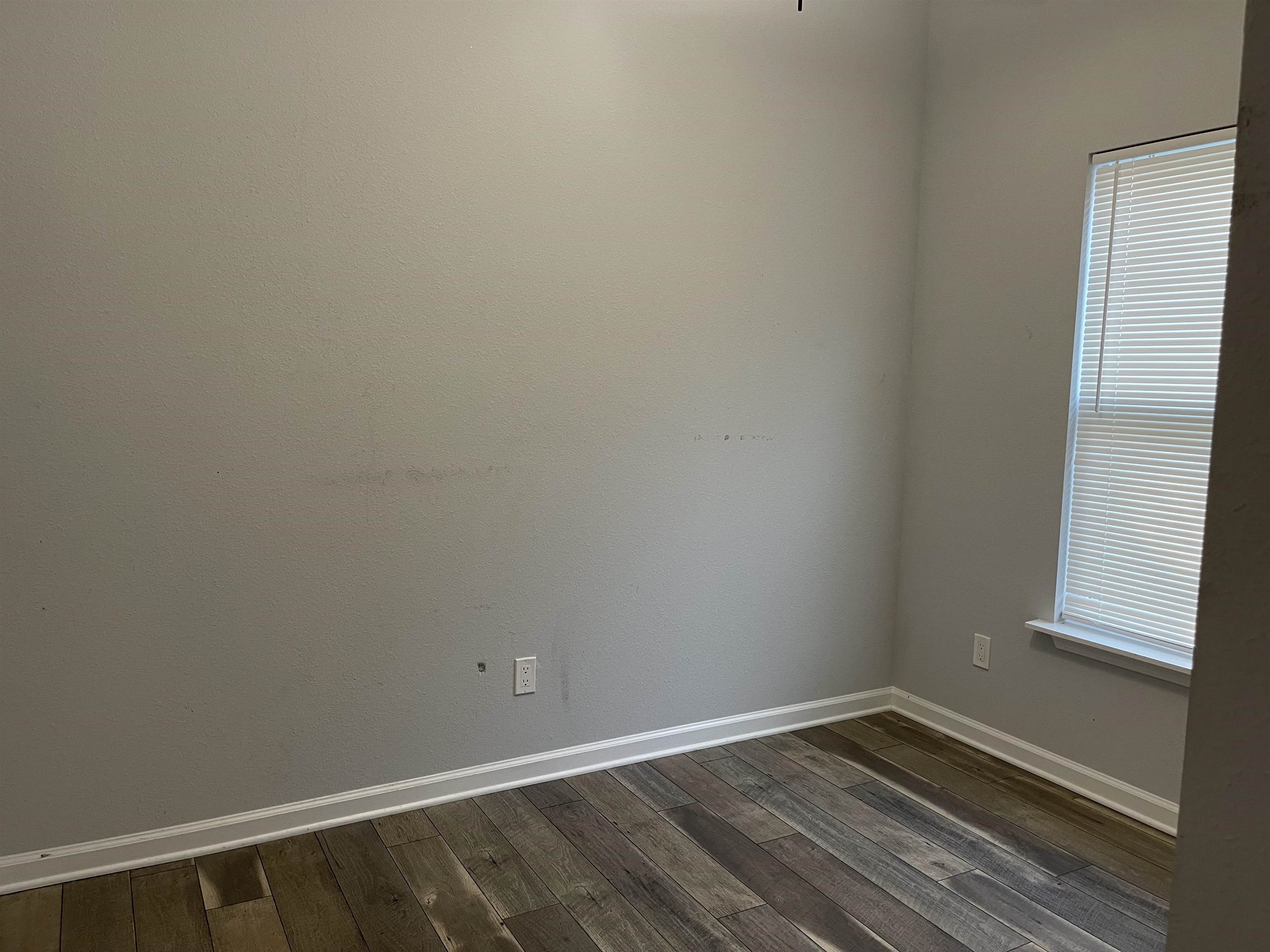 867 Helen Street St. Augustine, FL 32084 - Photo 8 of 11 a view of an empty room with wooden floor and a window