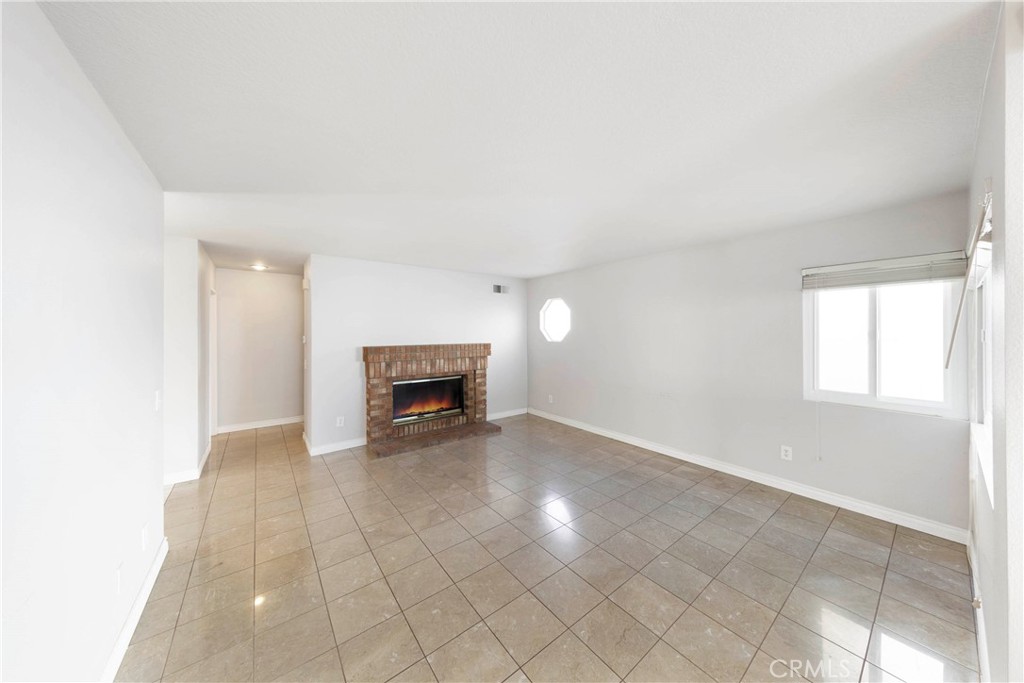 2 Bernini Irvine, CA 92614 - Photo 10 of 30 Cozy family room with enchanting brick fireplace.
