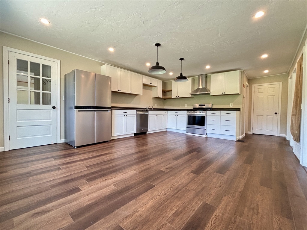 20 Town Farm Road Princeton, MA 01541 - Photo 21 of 42 an open kitchen with white cabinets wooden floor and stainless steel appliances