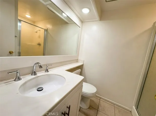 a bathroom with a double vanity sink mirror and shower