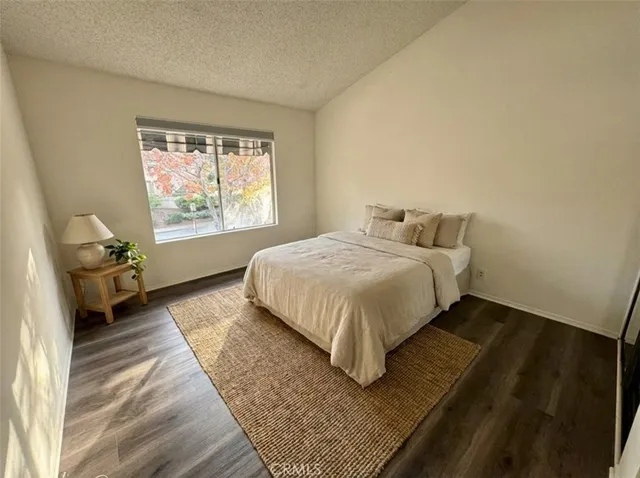 a bedroom with bed and window