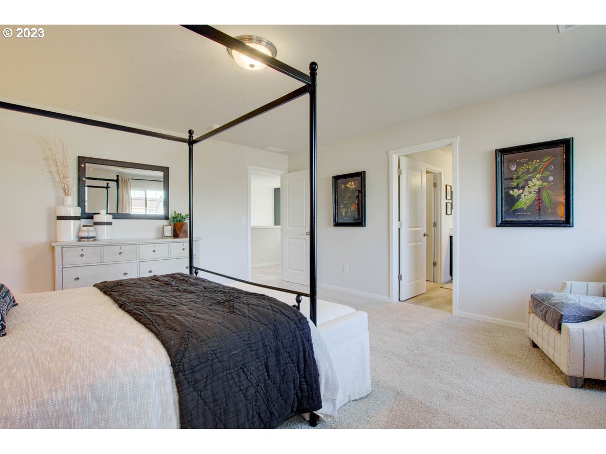 2632 26th Loop Springfield, OR 97477 - Photo 11 of 12 a bedroom with a bed and a chandelier