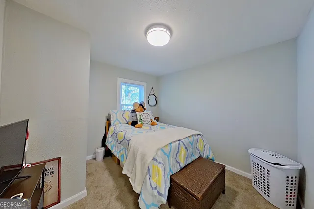 a bedroom with a bed and a tv