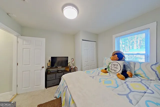 a bedroom with a bed and a tv