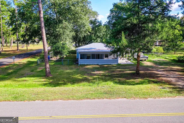 a swimming pool with outdoor seating and yard
