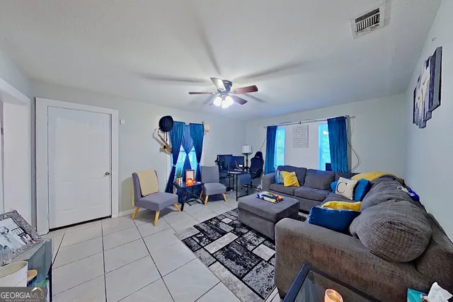 a living room with furniture a rug and a chandelier